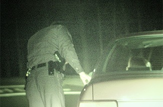 Officer at side of vehicle for traffic stop